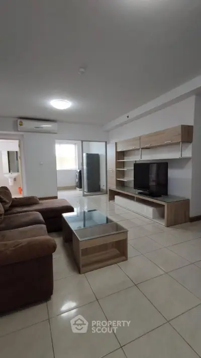 Spacious living room with modern furniture and entertainment center