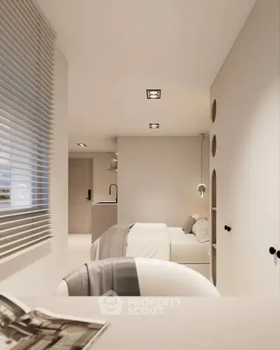 Modern minimalist bedroom with neutral tones and sleek design, featuring a cozy bed and stylish lighting.