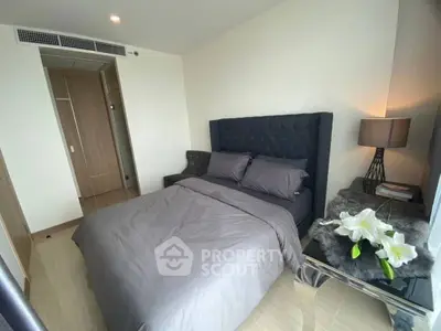Modern bedroom with elegant decor and plush bedding in a stylish apartment.