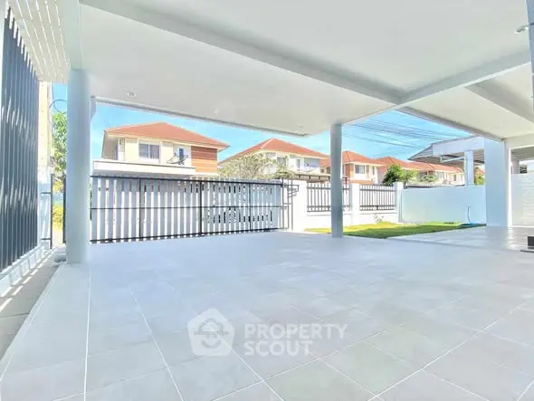 Spacious covered patio with modern design and neighborhood view.