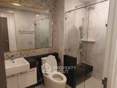 Modern bathroom with glass shower and elegant tile design