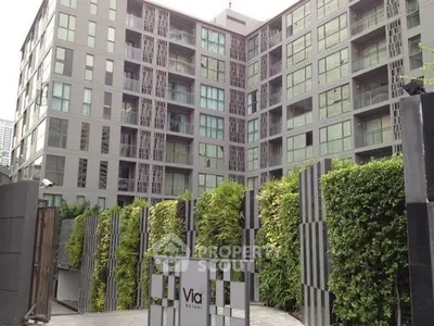 Modern urban condominium with lush greenery and sleek architectural design.