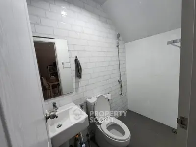 Modern bathroom with white subway tiles and sleek fixtures