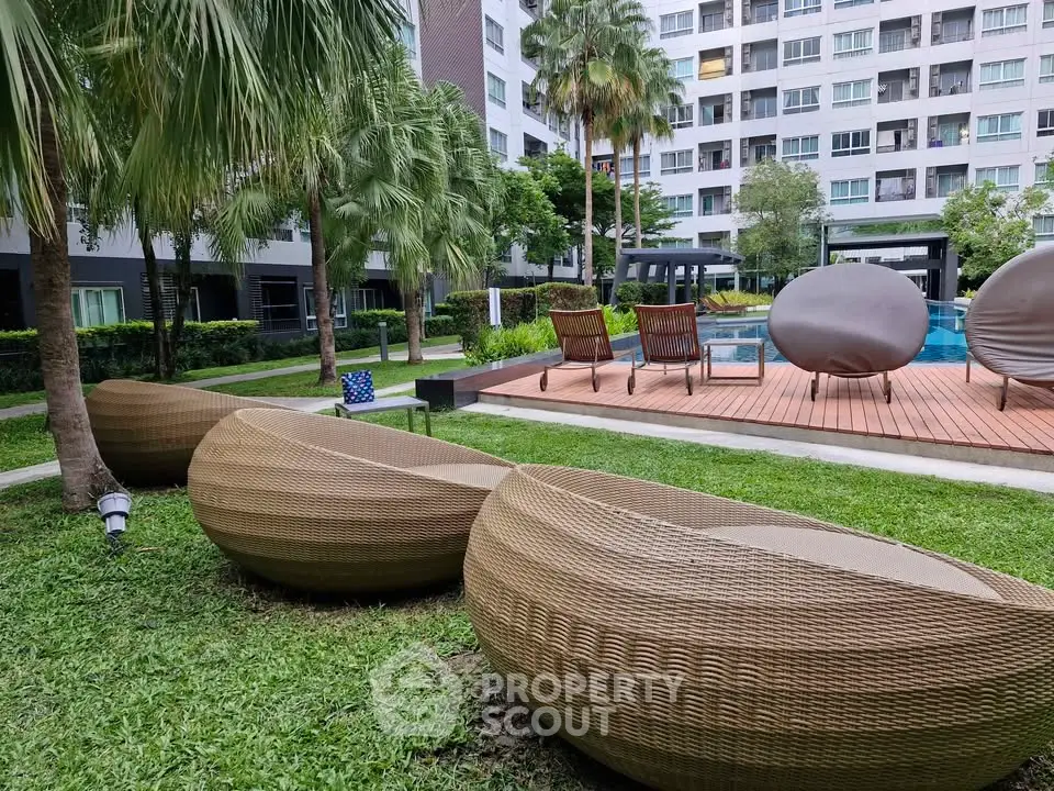 Modern apartment complex with stylish outdoor seating and lush greenery
