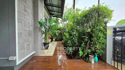 Charming garden entrance with lush greenery and modern design, perfect for a serene home ambiance.