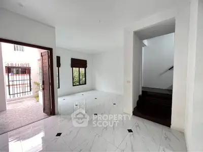 Spacious modern living area with marble flooring and open entrance