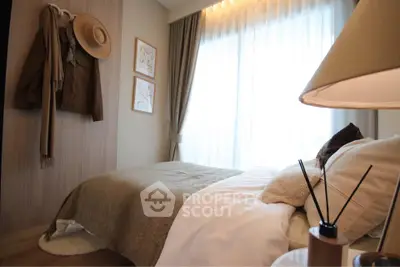 Cozy bedroom with natural light, stylish decor, and warm tones for a relaxing ambiance.