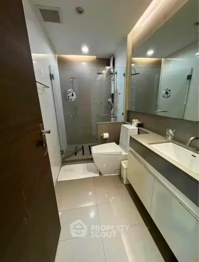 Modern bathroom with sleek fixtures and glass shower enclosure