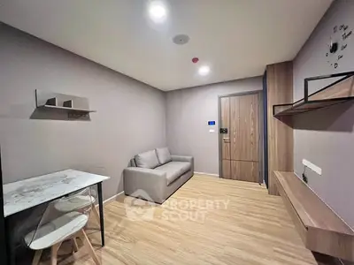 Modern minimalist living room with sleek furniture and wooden flooring