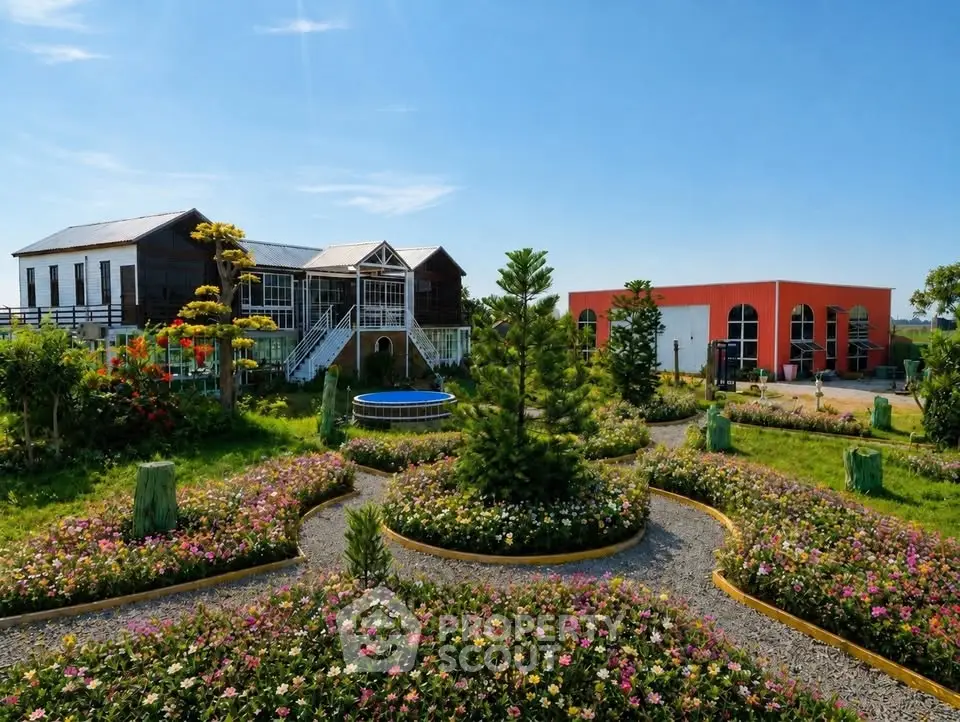 Stunning garden view with modern building and lush landscaping under clear blue sky.