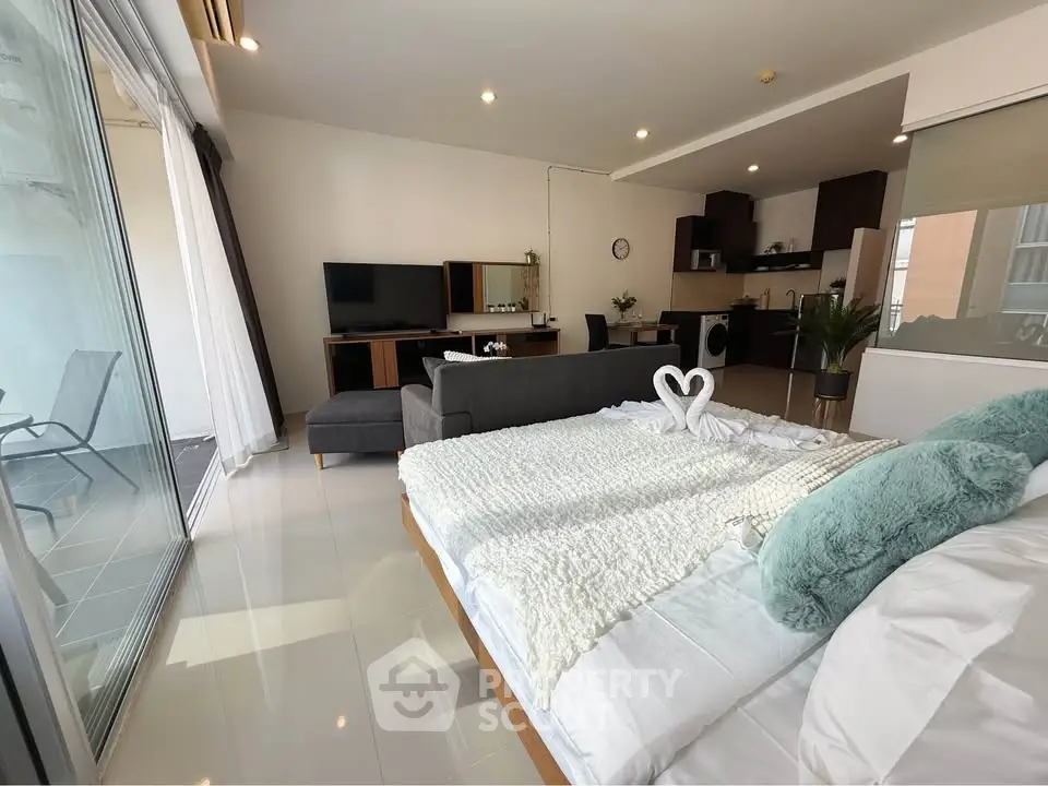 Spacious modern studio with open layout and balcony access