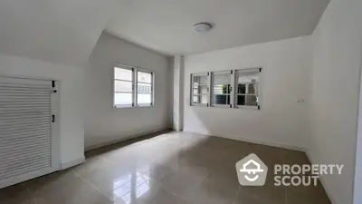 Spacious unfurnished room with tiled floor and large windows in modern home