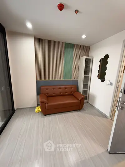 Modern living room with stylish sofa and unique wall design