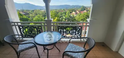 Charming balcony with scenic mountain and greenery view, perfect for relaxation.