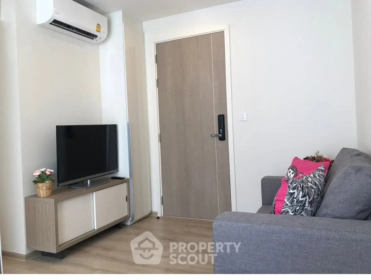 Modern living room with sleek furniture and air conditioning in a cozy apartment.