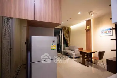 Modern apartment with open kitchen and cozy living area, featuring sleek furniture and stylish lighting.