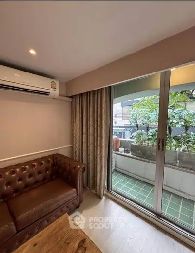 Cozy living room with leather sofa and balcony view