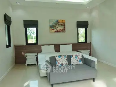 Spacious bedroom with modern decor and natural light