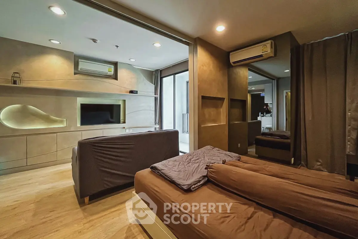 Modern studio apartment with open layout, featuring cozy living area and stylish bedroom.