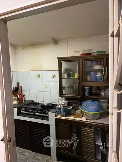 Cozy kitchen with gas stove and ample storage in a compact layout, perfect for efficient cooking.