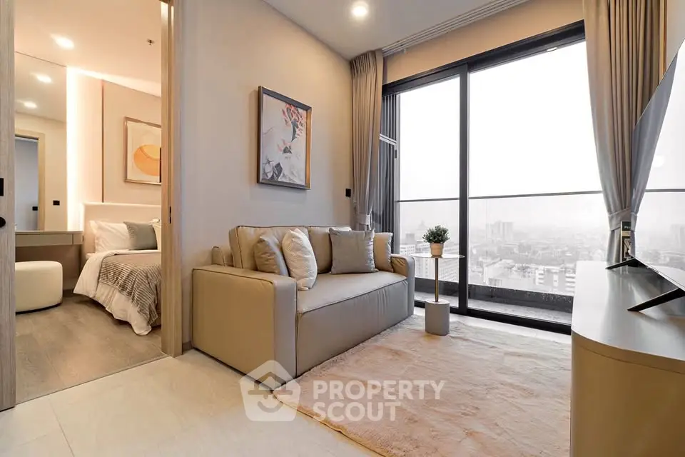Modern living room with city view, cozy sofa, and elegant decor in a high-rise apartment.