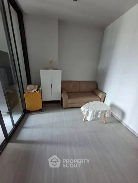 Cozy small living room with sofa, cabinet, and table in modern apartment.