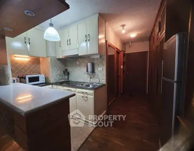 Charming kitchen with closed layout and modern appliances in cozy apartment