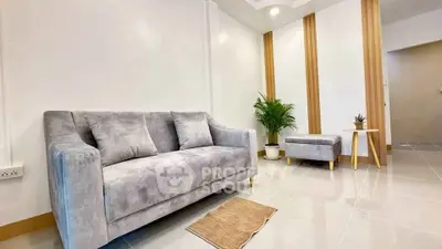 Modern living room with gray sofa and stylish decor