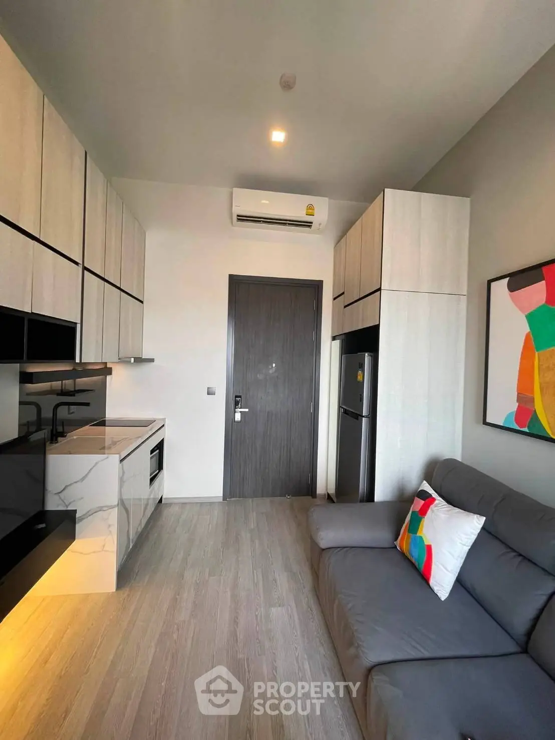 Modern compact living room with sleek kitchen and stylish decor