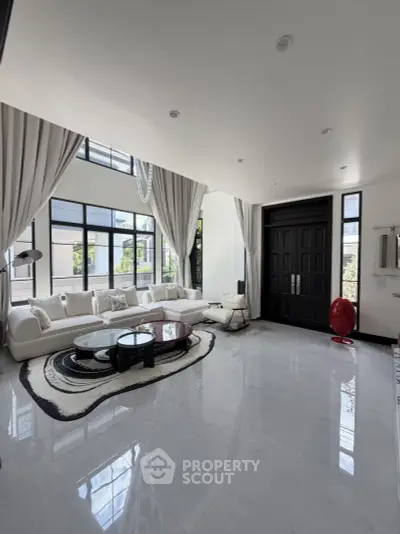 Luxurious modern living room with high ceilings and elegant decor