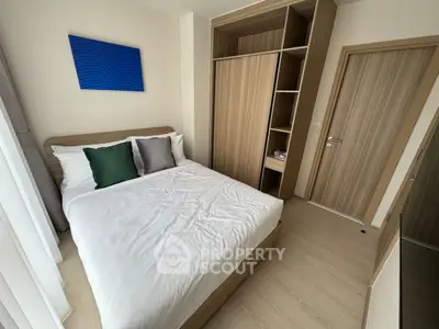 Modern bedroom with stylish wooden wardrobe and cozy bed setup.