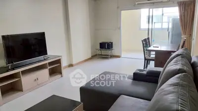 Spacious living room with modern furniture and natural light, perfect for relaxation and entertainment.