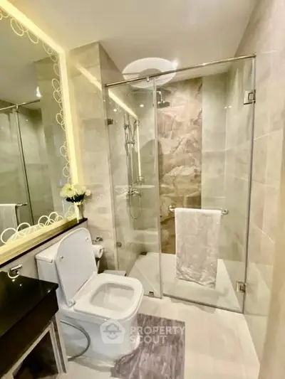 Modern bathroom with glass shower and elegant fixtures