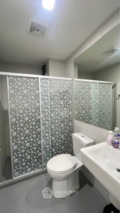 Modern bathroom with floral glass shower doors and sleek fixtures