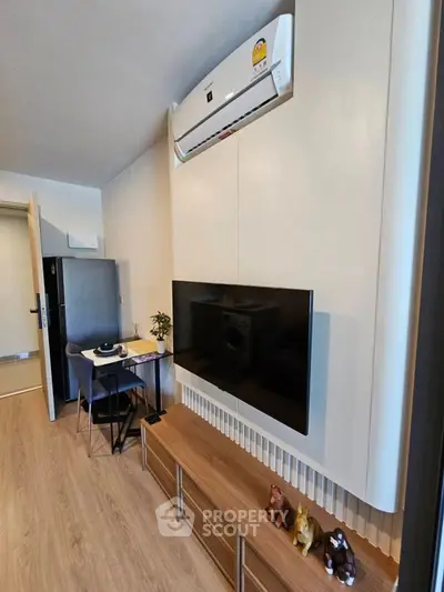 Modern living room with wall-mounted TV and air conditioning unit