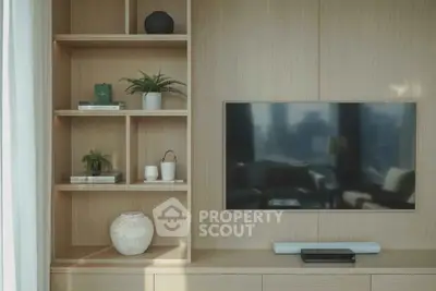 Modern living room with built-in shelves and flat-screen TV, perfect for stylish urban living.