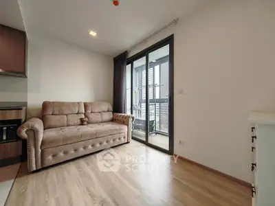 Modern living room with plush sofa and balcony access in a stylish apartment.