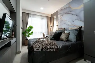 Luxurious bedroom with modern decor and natural light, featuring stylish bedding and a large window.