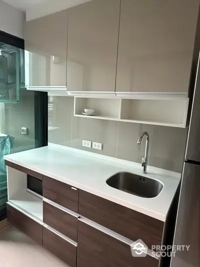 Modern kitchen with sleek cabinets and stainless steel sink