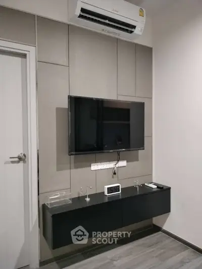 Modern living room with wall-mounted TV and sleek air conditioning unit