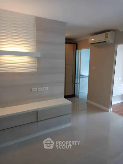 Modern interior with sleek design, featuring built-in storage and air conditioning in a bright living space.