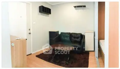 Cozy living room with modern furniture and wooden flooring, perfect for relaxation and entertainment.