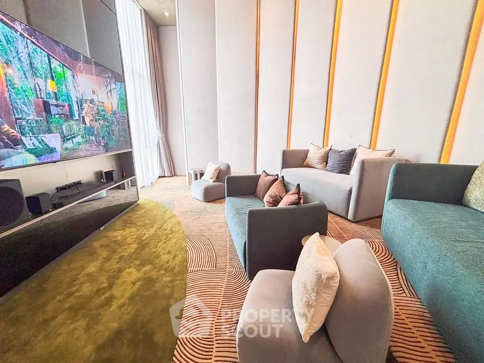 Luxurious modern living room with plush seating and large TV, perfect for entertainment.