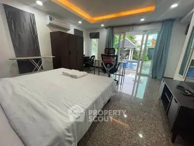 Spacious bedroom with pool view and modern amenities