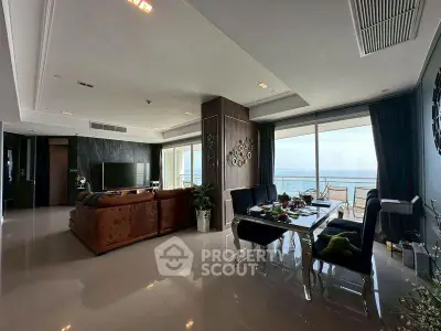 Luxurious living room with ocean view and elegant decor in a high-end apartment.
