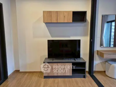 Modern living room with sleek TV stand and wall-mounted cabinet