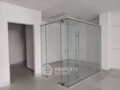 Modern office space with glass partition and sleek design