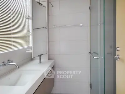 Modern bathroom with sleek fixtures and glass shower enclosure