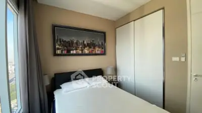 Modern bedroom with cityscape artwork and sliding closet doors