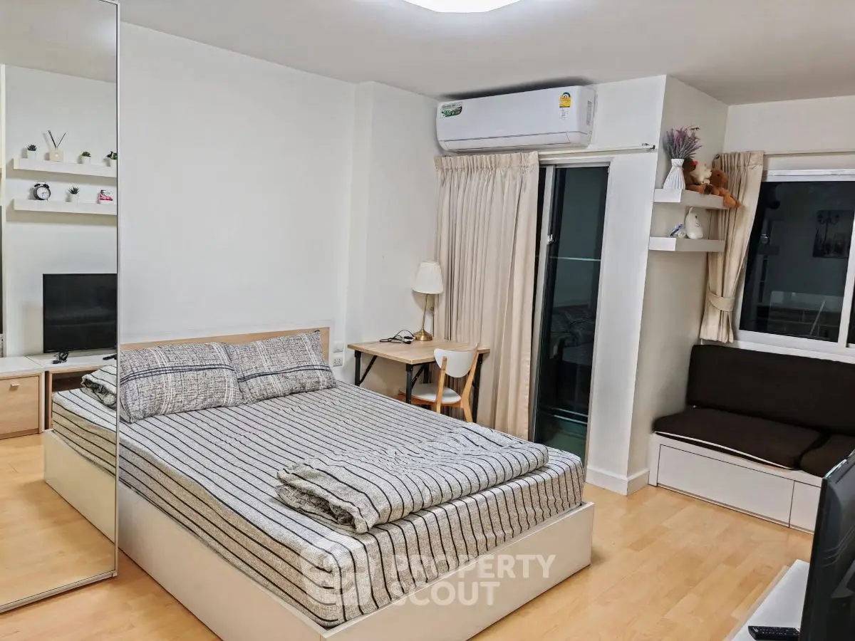 Cozy modern bedroom with mirrored closet and balcony access